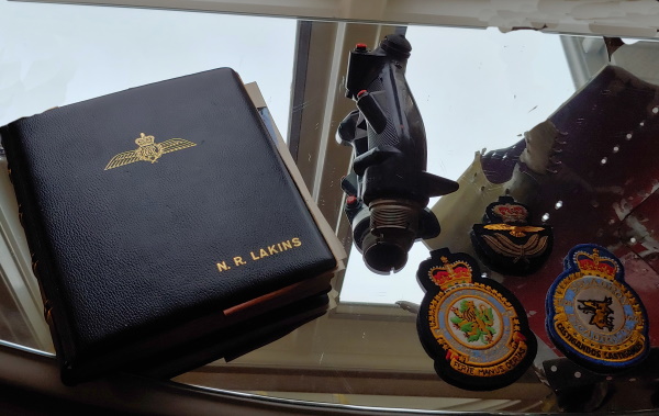 Flying logbook, the Sabre handgrip from the control 
			 					column and squadron crests, 427 and 424